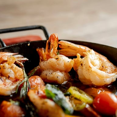 Gulf shrimp sizzling in a cast iron pan